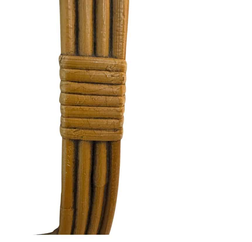 Close-up of a vintage oval bamboo frame showcasing its intricate design and natural texture.