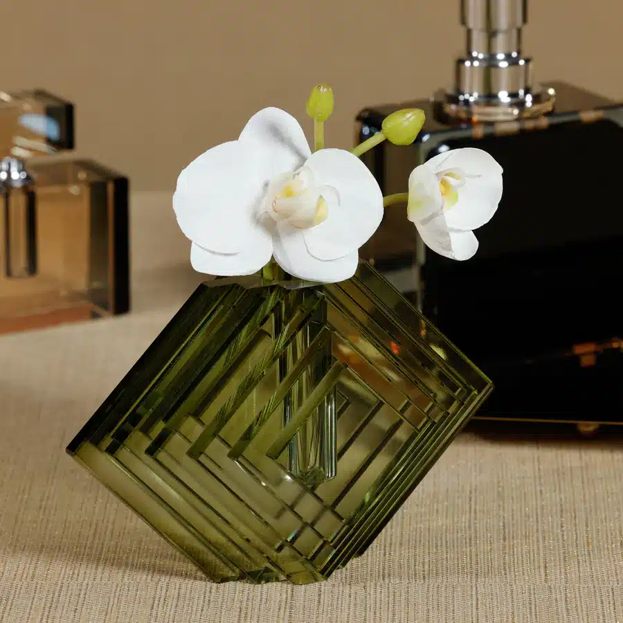 Green stacked concentric diamond motif glass vase in front view.