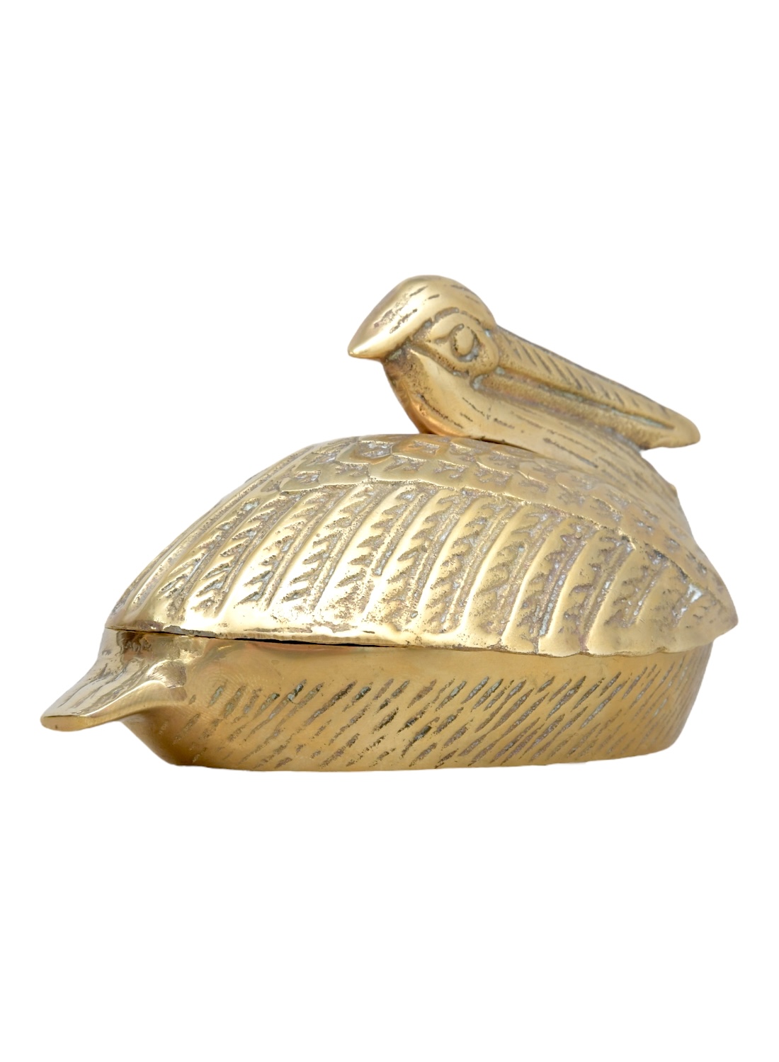 Close-up of vintage brass pelican box with intricate details.