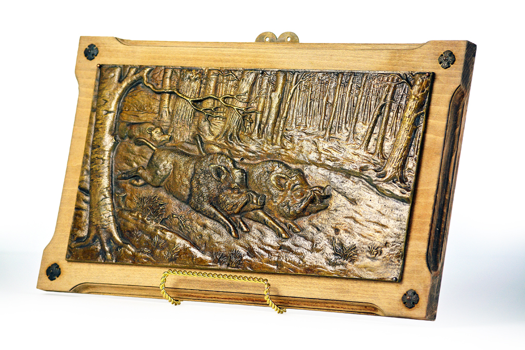 Antique French bronze wall plaque with relief depiction of wild boars, mounted on walnut, circa 1860.