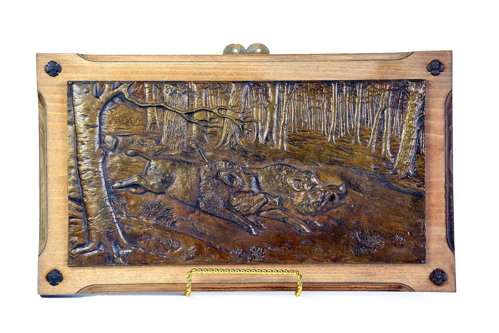 Antique French bronze wall plaque with relief depiction of wild boars, mounted on walnut, circa 1860.