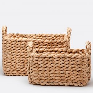 Three woven seagrass baskets in a row with two handles on each end of the large basket and one handle on top