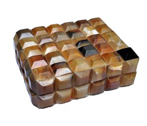 A faceted horn box with a lid, showcasing its intricate design and craftsmanship.