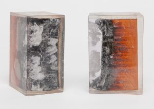 Two square bookends with a burnt wood and resin design, each piece varying slightly in appearance.