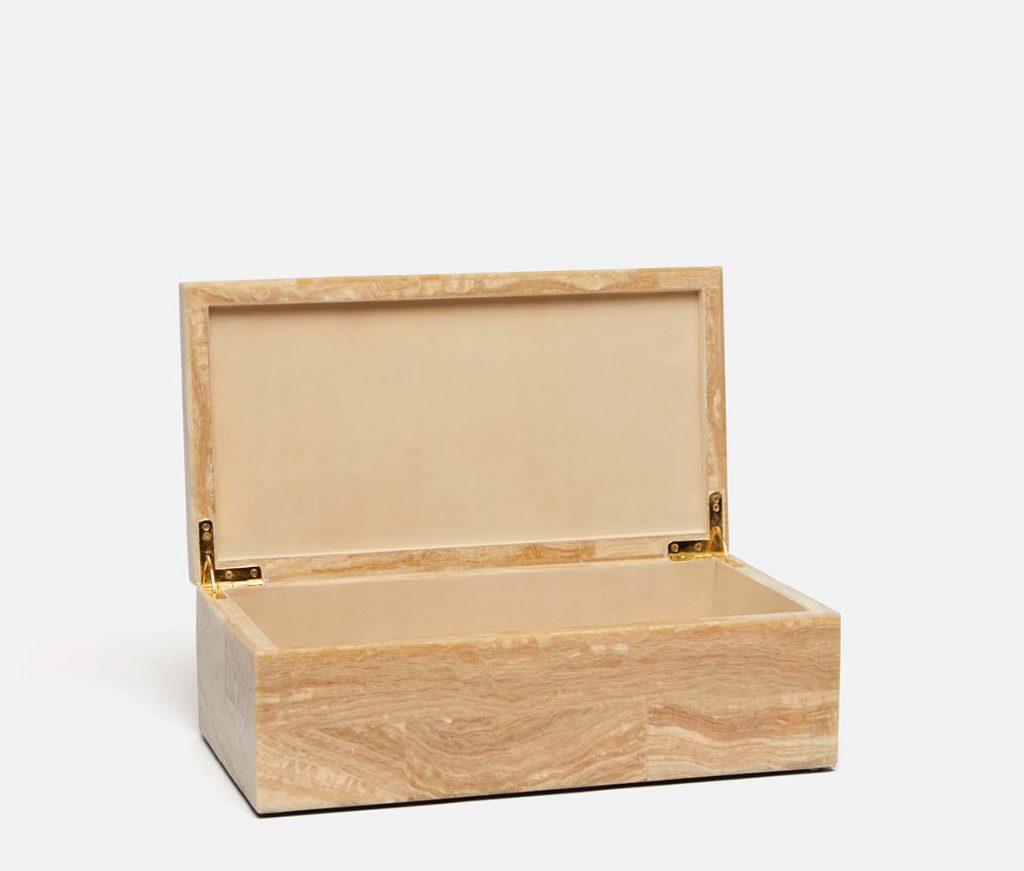 Wooden box with a velvet interior, placed on a white surface.