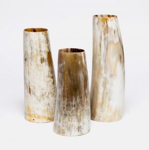 Three large curved horn vases with a rough texture and natural color variations displayed against a white background The largest vase is
