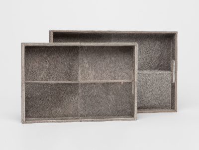 Two large Durst cowhide trays with a gray hair-on-hide texture, showcasing their natural variation against a white background.