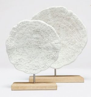 Two faux mushroom corals on stands one larger and one smaller displayed against a white background with a wooden stand in between
