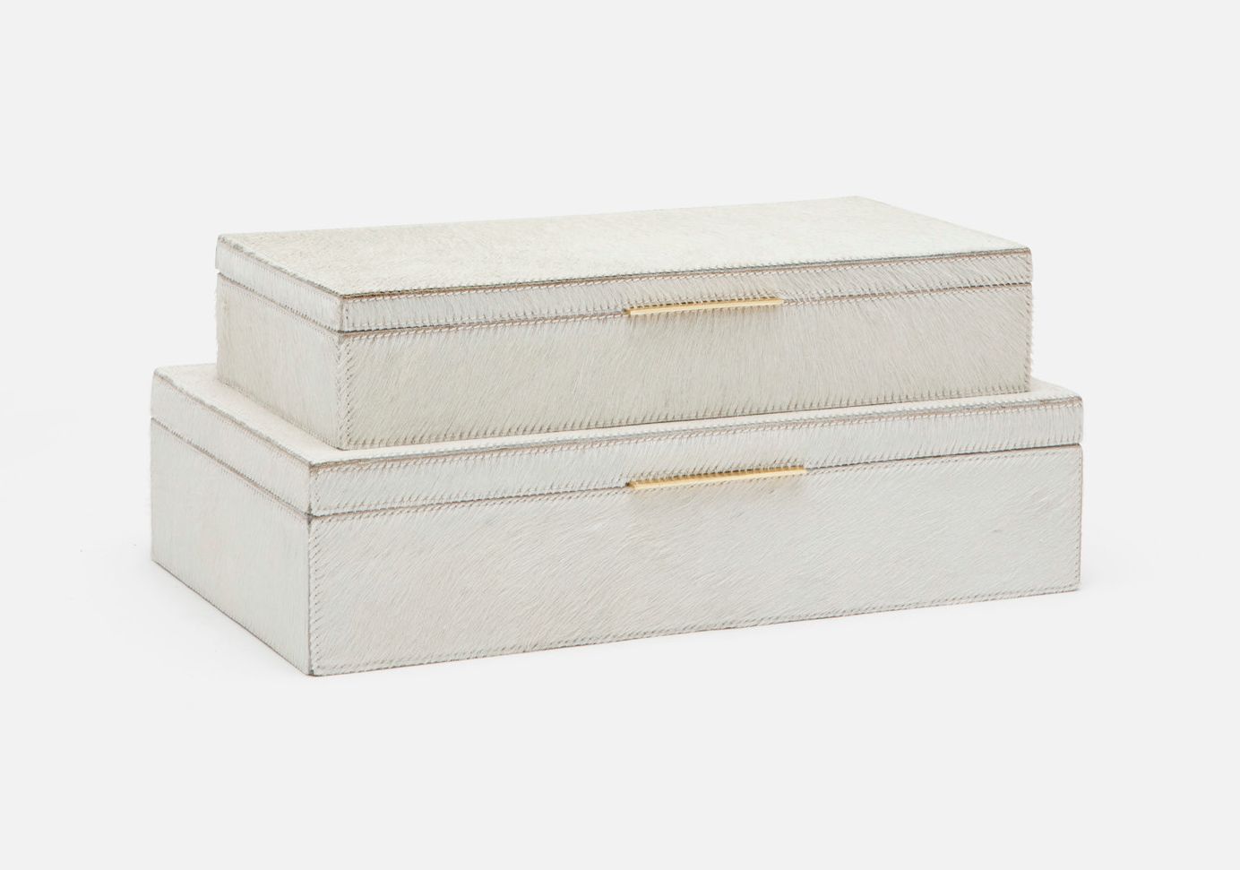 Two rectangular leather boxes with brass handles, one on top of the other against a white background.