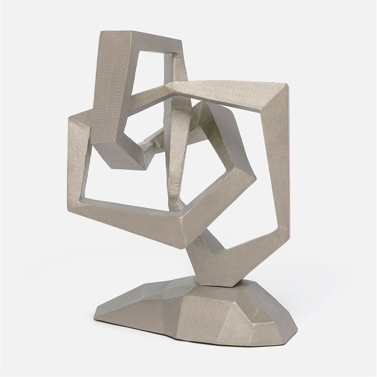 A modern abstract sculpture with a geometric design, featuring interconnected shapes in silver and brass tones.