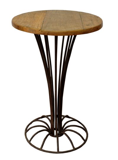 Antique round deco side table with a curved metal base and a wooden top featuring an iron rod design and a weathered