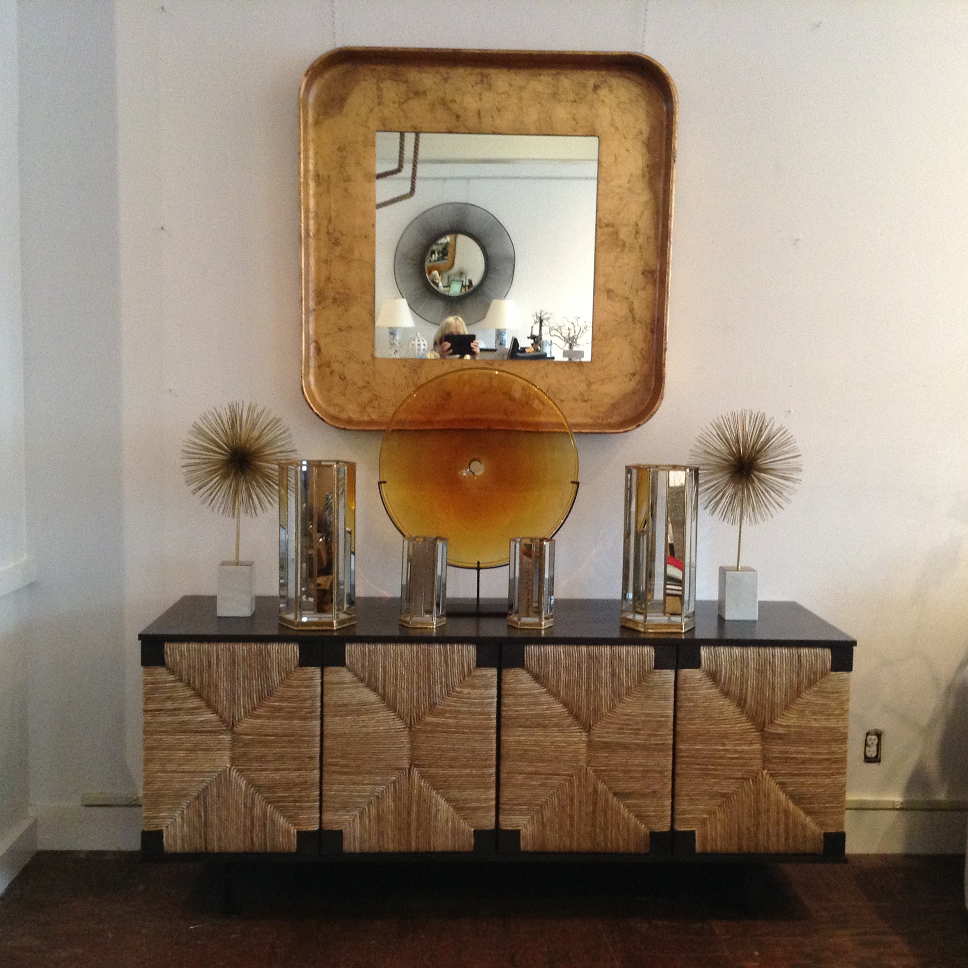 Mahogany Rush Buffet with four doors, set against a white wall, placed on a wooden floor.