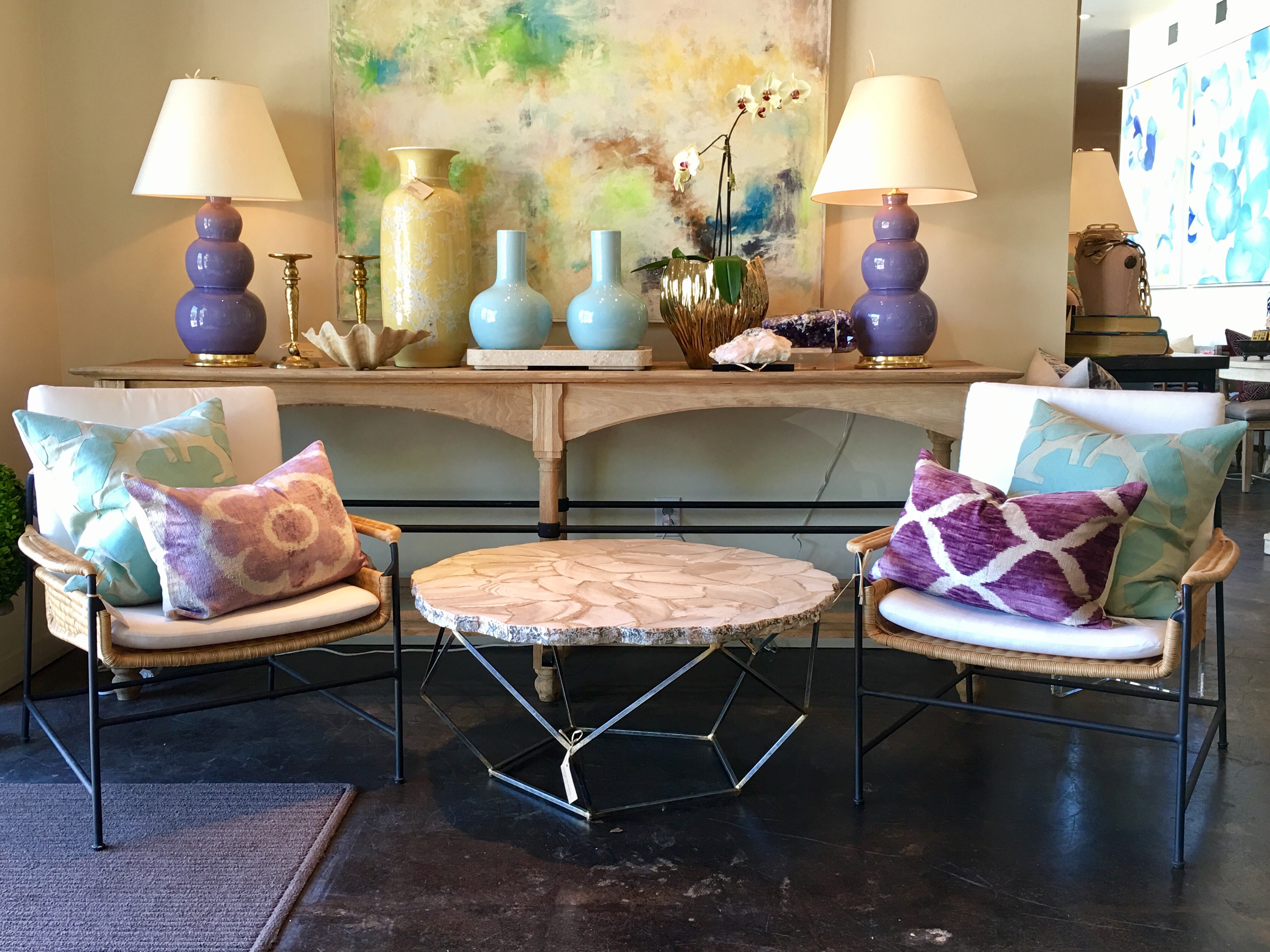 A modern living room scene featuring a vibrant blue and white abstract painting a wooden console table with decorative items two stylish