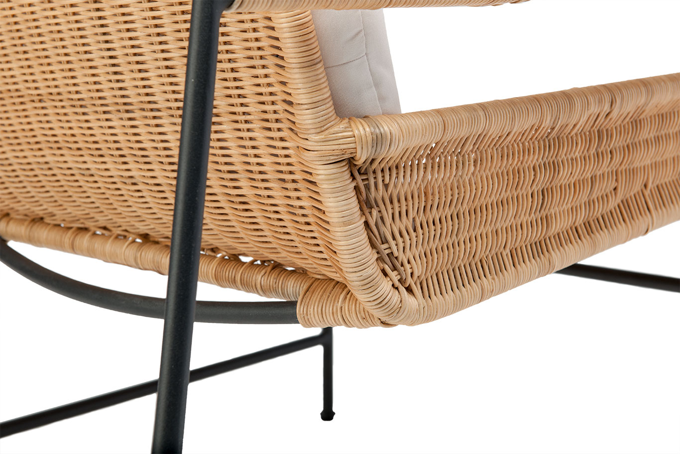 A wicker and metal club chair with a cushioned seat and backrest, showcasing its natural sunbrella fabric.