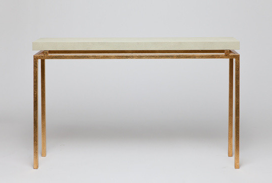 Small, modern console table with a marble top and gold accents.