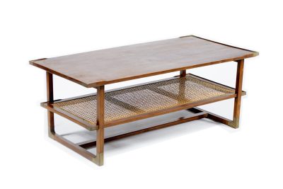 Wooden coffee table with two shelves and brass endcaps, set against a white background