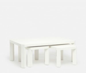 White nesting coffee table with angled legs available in two finishes pristine or seal faux raffia dimensions 52 L x 30 W