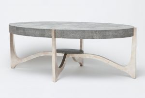 The image shows a modern coffee table with a unique design It features a marble-like surface in shades of gray and white