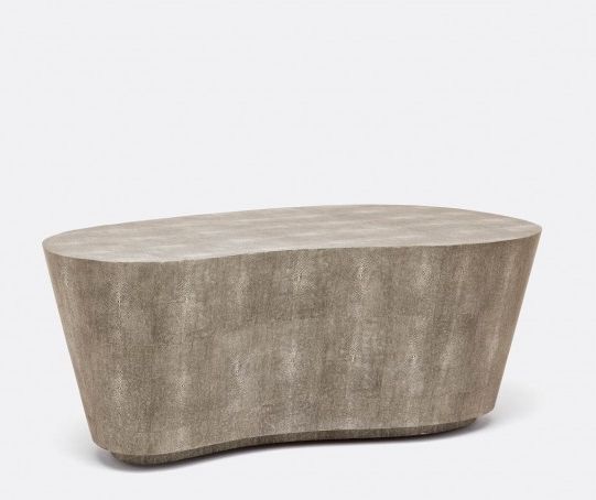 Kidney shaped mid-century modern coffee table with a smooth, curved surface and a faux shagreen finish in either sand or grey color.
