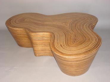 Organic shaped striped wood coffee table with rattan strip and coco twig veneer covered in resin contemporary undulating shape available as a