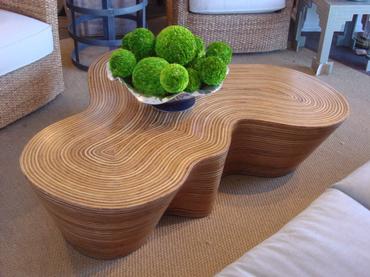 Organic striped wood coffee table with a curved design, featuring rattan strip and coco twig veneer covered in resin.
