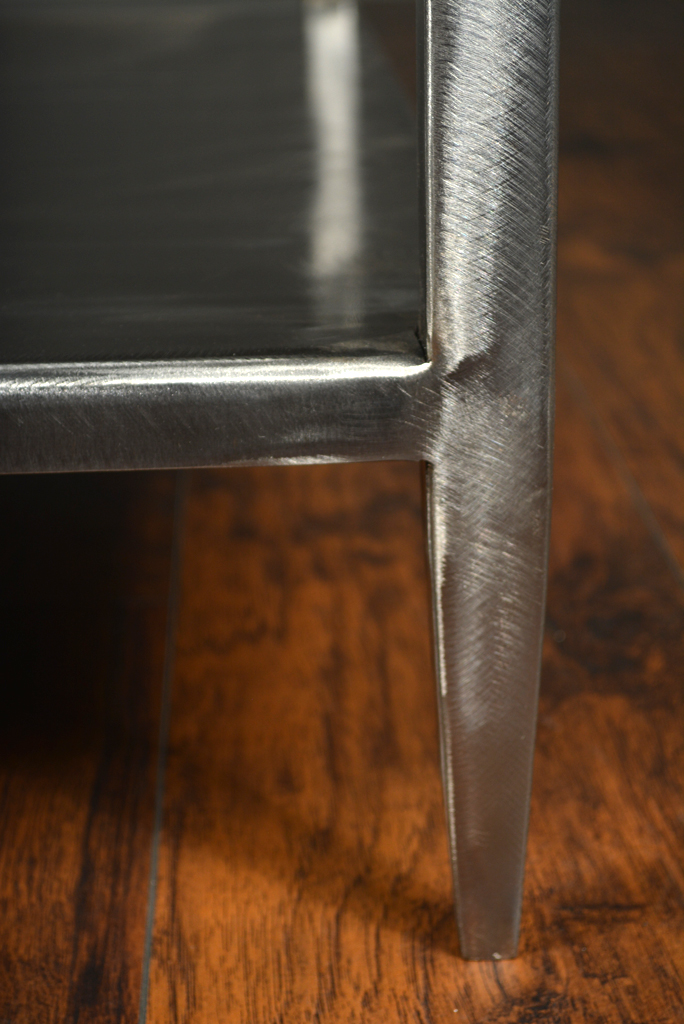 Brushed steel coffee table with slightly tapered legs and open bottom shelf limited stock available custom sizes and finishes available also available