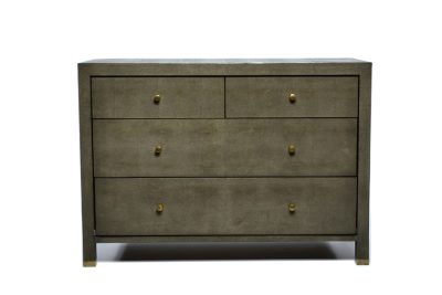Dresser with four drawers, featuring a faux shagreen finish and brass hardware, displayed in a close-up view against a white background.