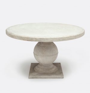 Round concrete dining table with a light gray finish, set against a white background.