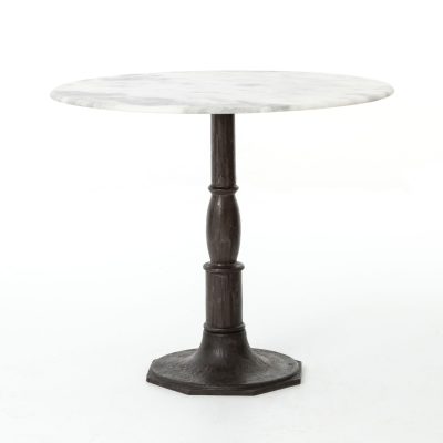 Round bistro table with cast iron base and white marble top.