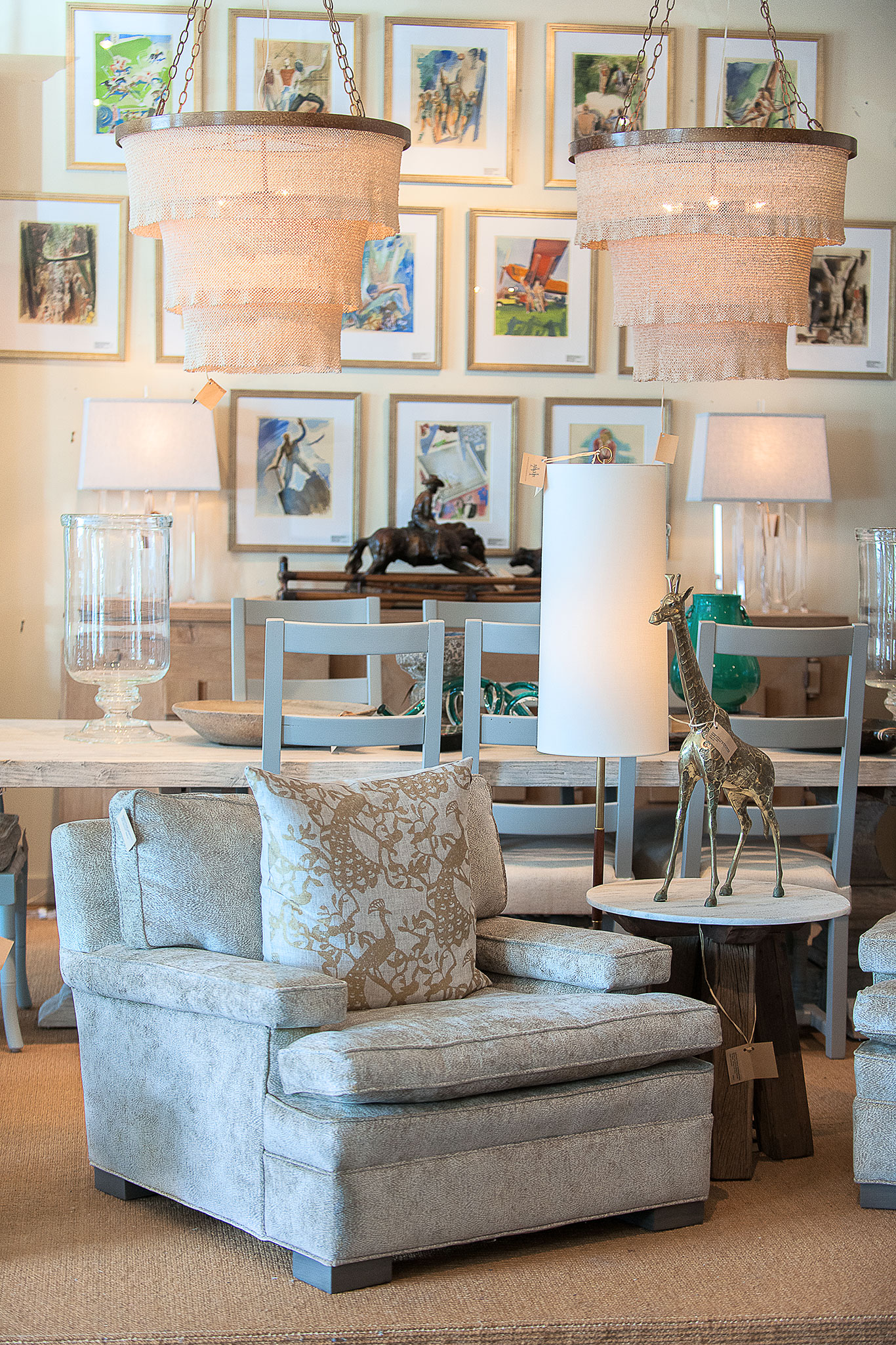 Round three tier beaded chandelier with gold frame and 5 lights hanging from ceiling in a living room above a dining table