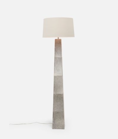 Gray cowhide floor lamp with a tapered base and silk drum shade.