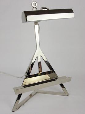 A sleek, modern table lamp with a chrome finish and a three-tiered base.