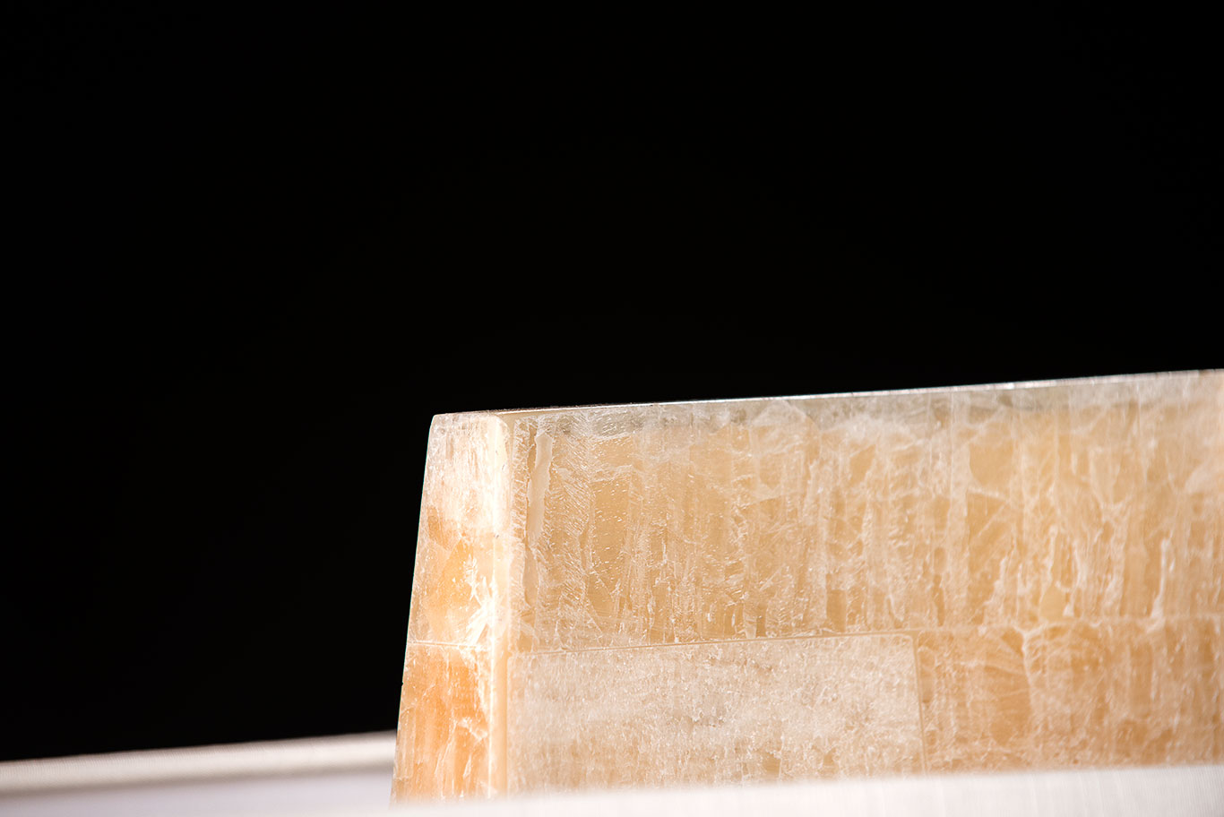A modern faux bone obelisk table lamp with a rectangular shade.