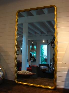 Large scalloped mirror with antique gold leaf art nouveau design from late 19th century Paris, featuring undulating moulding and customizable finishes.
