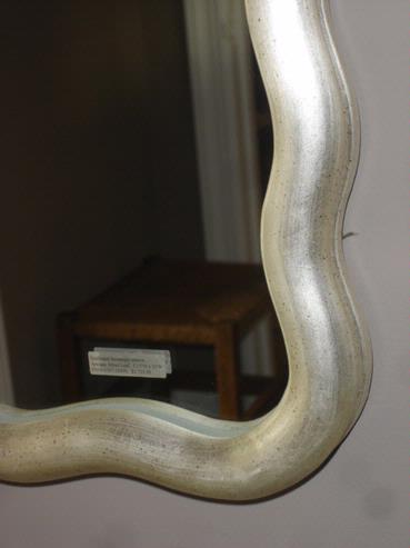 Large scalloped mirror with antique gold leaf finish inspired by art nouveau design from late 19th century Paris featuring undulating moulding along