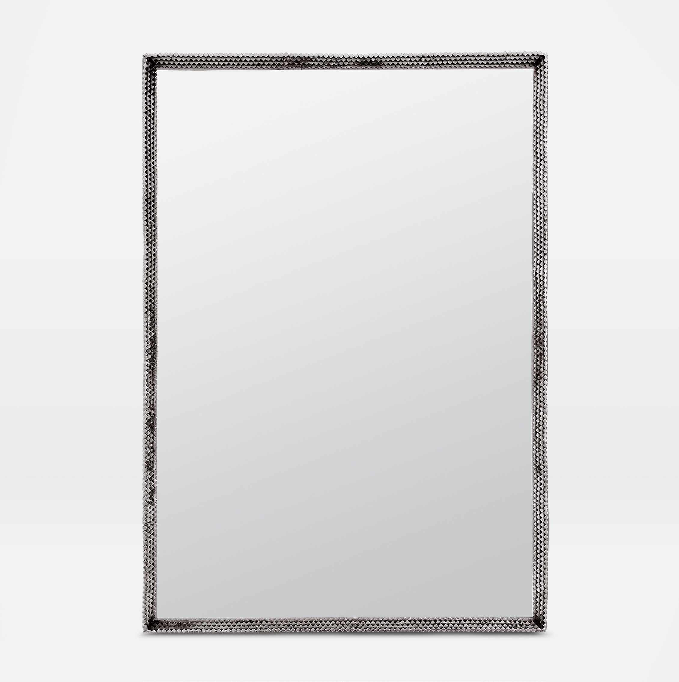 Metal mirror with a tramp art style, featuring an antiqued silver or polished brass frame, set against a white background.
