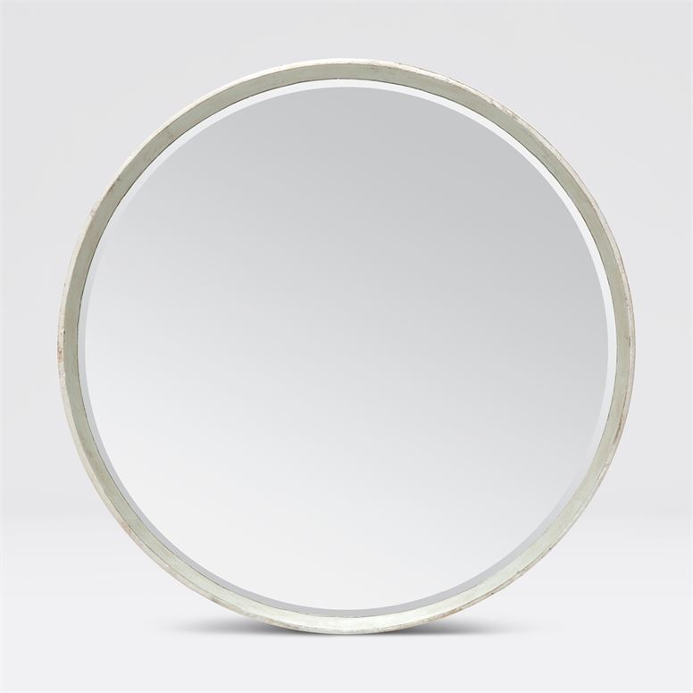 Round mirror with a silver frame and a white background.