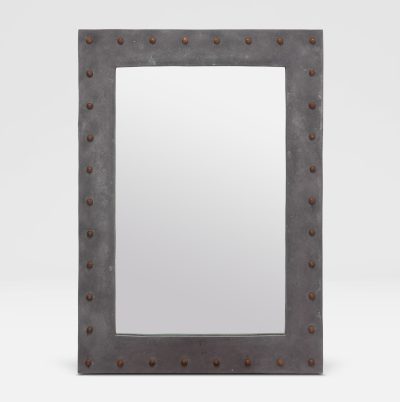 A weathered gray outdoor stud concrete resin mirror with metal bolts, mounted on a white wall.