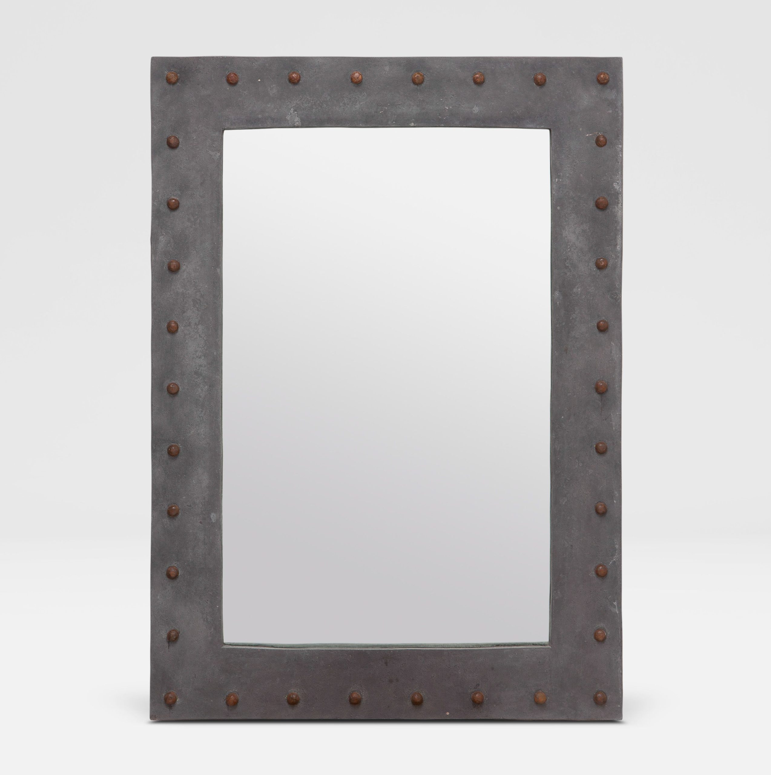 A weathered gray outdoor stud concrete resin mirror with metal bolts, mounted on a white wall.