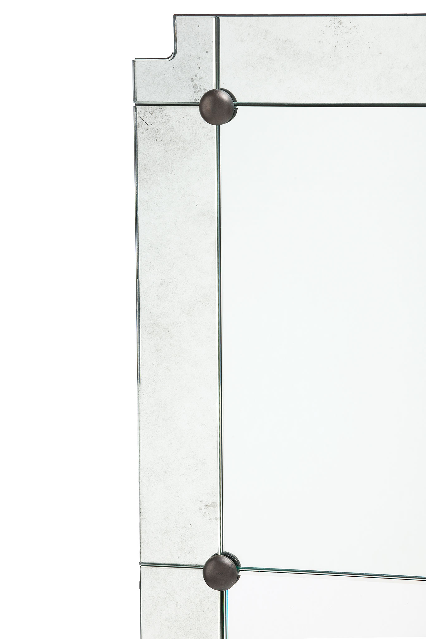 A rectangular mirror with a paneled design and gold details, featuring clipped corners and an aged border.