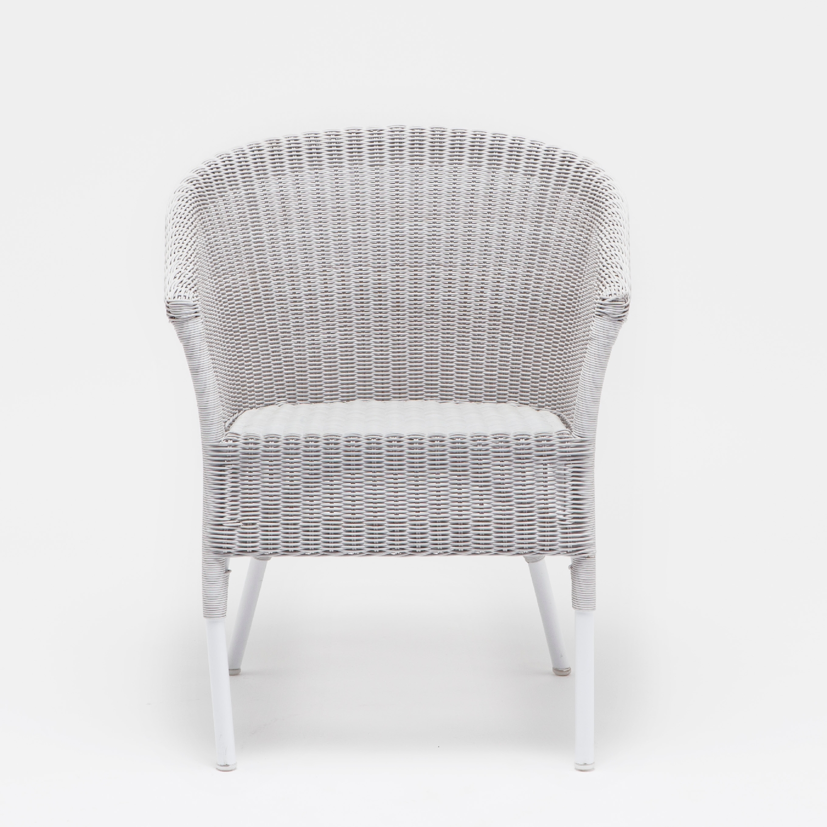 White wicker armchair with a rounded back, set against a white background.