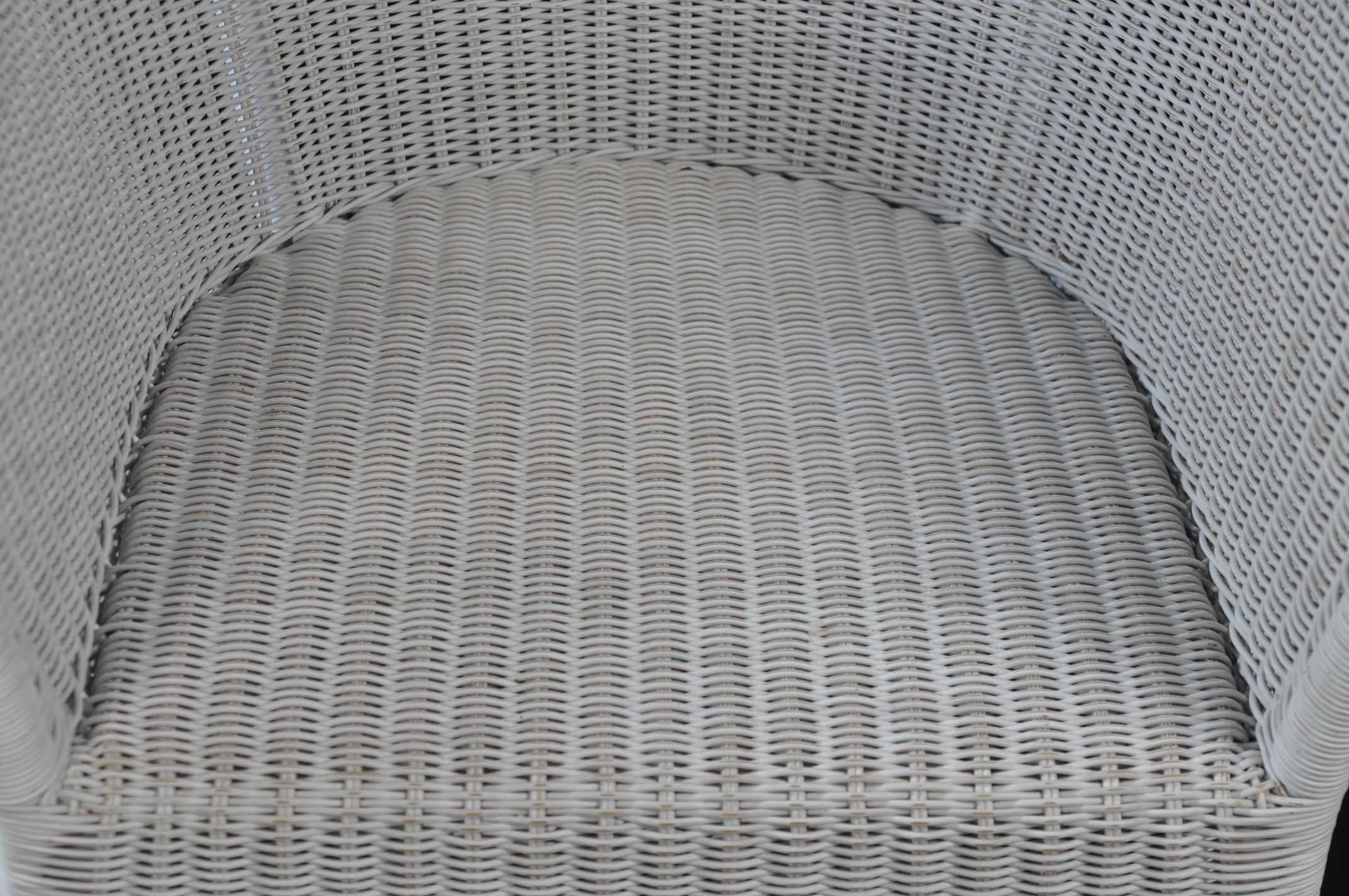 Kamp Outdoor Wicker Arm Chair, available in white or grey finish, shown from a side perspective