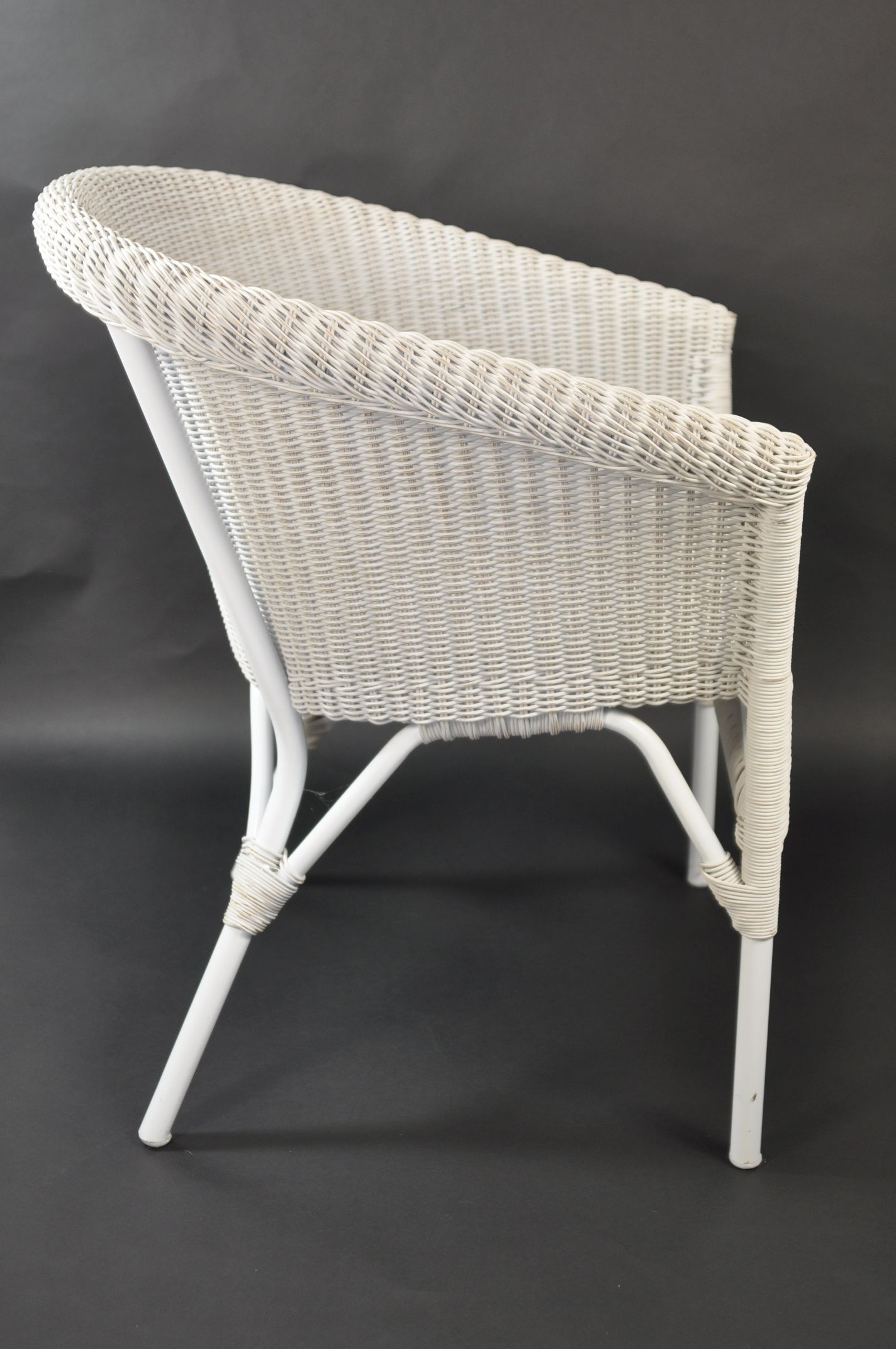 A wicker outdoor armchair with a rounded back, available in white or grey finish.