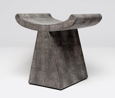 Grey faux shagreen stool with a modern design, featuring a geometric shape and a unique angular seat.