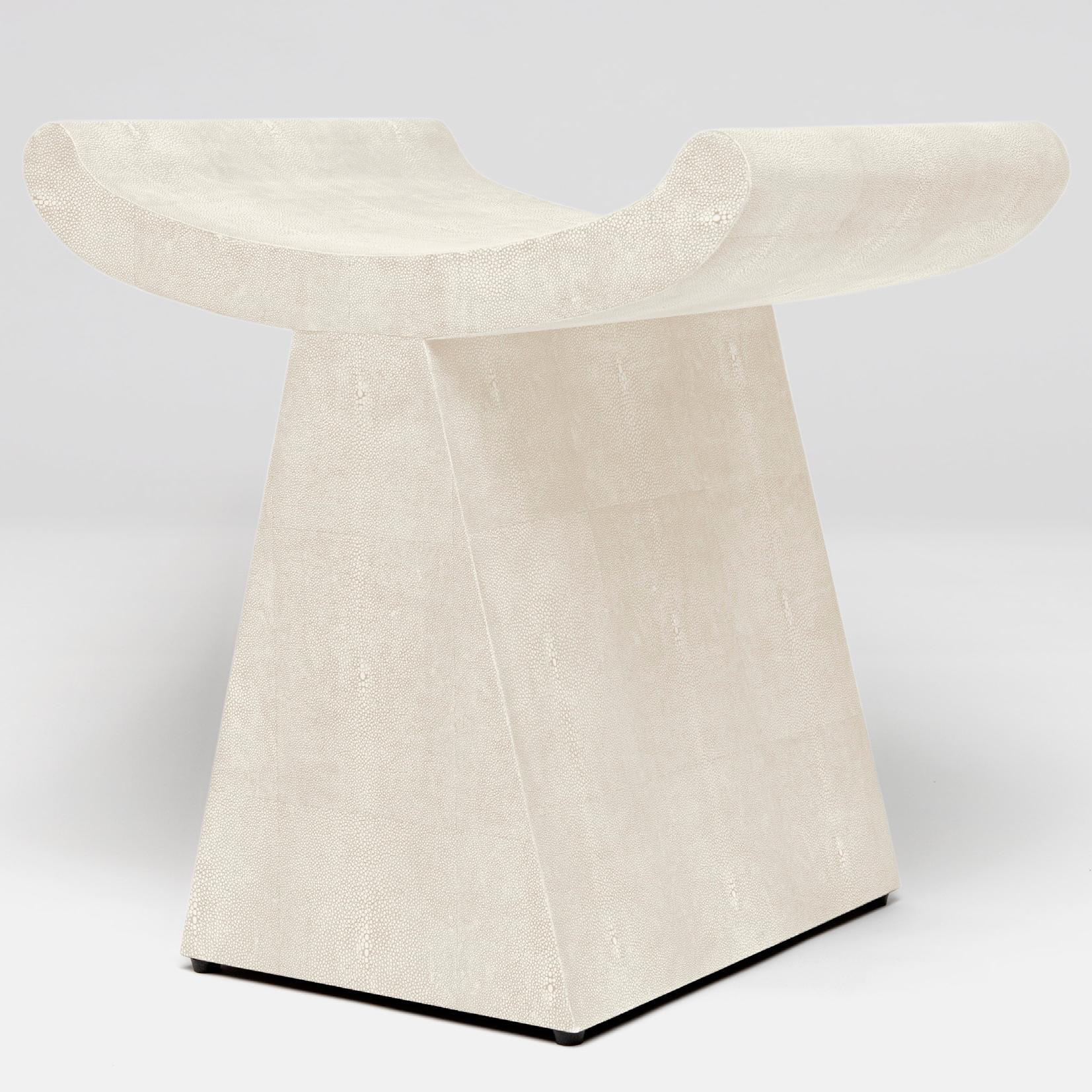 The image features a modern stool with a unique design showcasing its cool grey faux shagreen upholstery It is an Anni Art