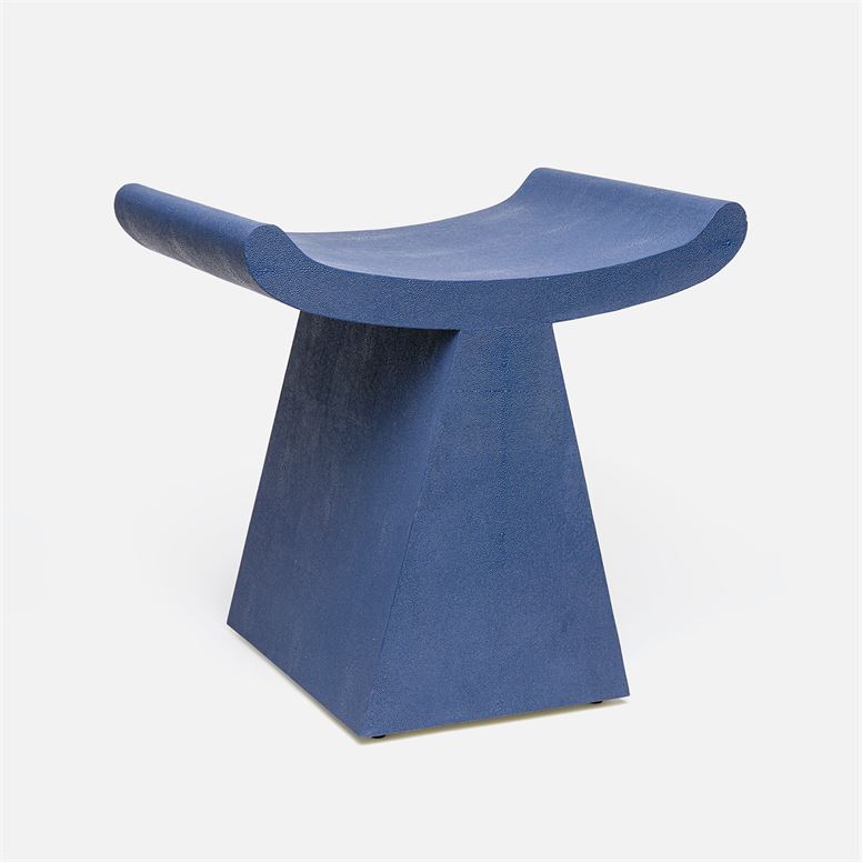 A blue Anni Art Deco stool with a modern design, featuring a unique geometric shape and a smooth faux shagreen finish.