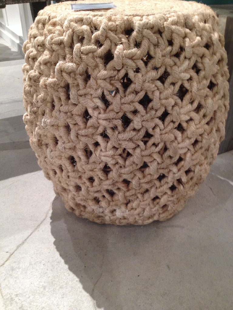 Rope stool with a woven design, featuring a circular shape and a natural color.
