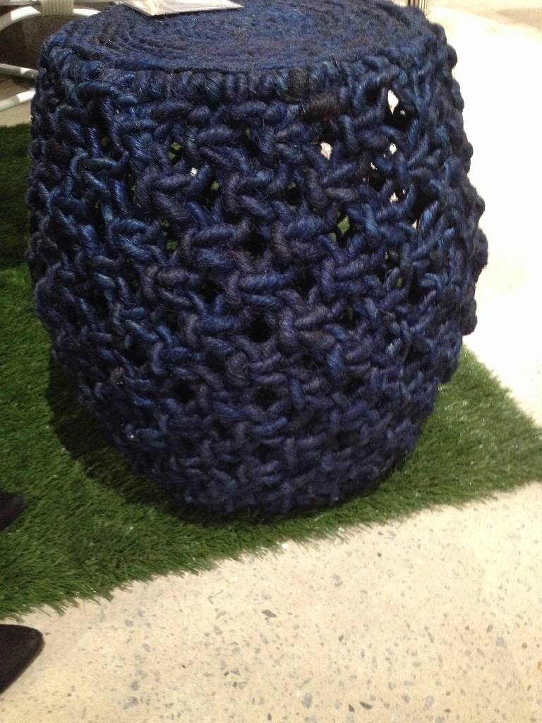 The image displays a blue Angela Abaca Rope Stool showcasing its intricate knit design and the rope texture that gives it a