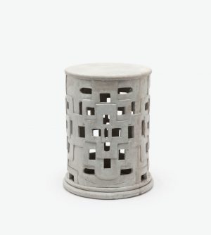 This image features a handcrafted outdoor patched cut out concrete stool with variation in size between pieces and minor cracks and imperfections