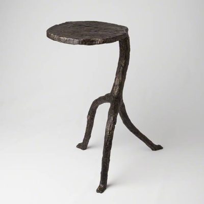 A small, round-topped side table with a rustic iron tripod base.